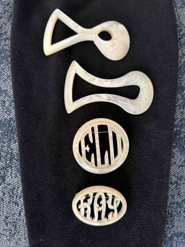 Collection of Mother-of-Pearl Items: Two Belt or Sash Buckles and Two Monogrammed Brooches