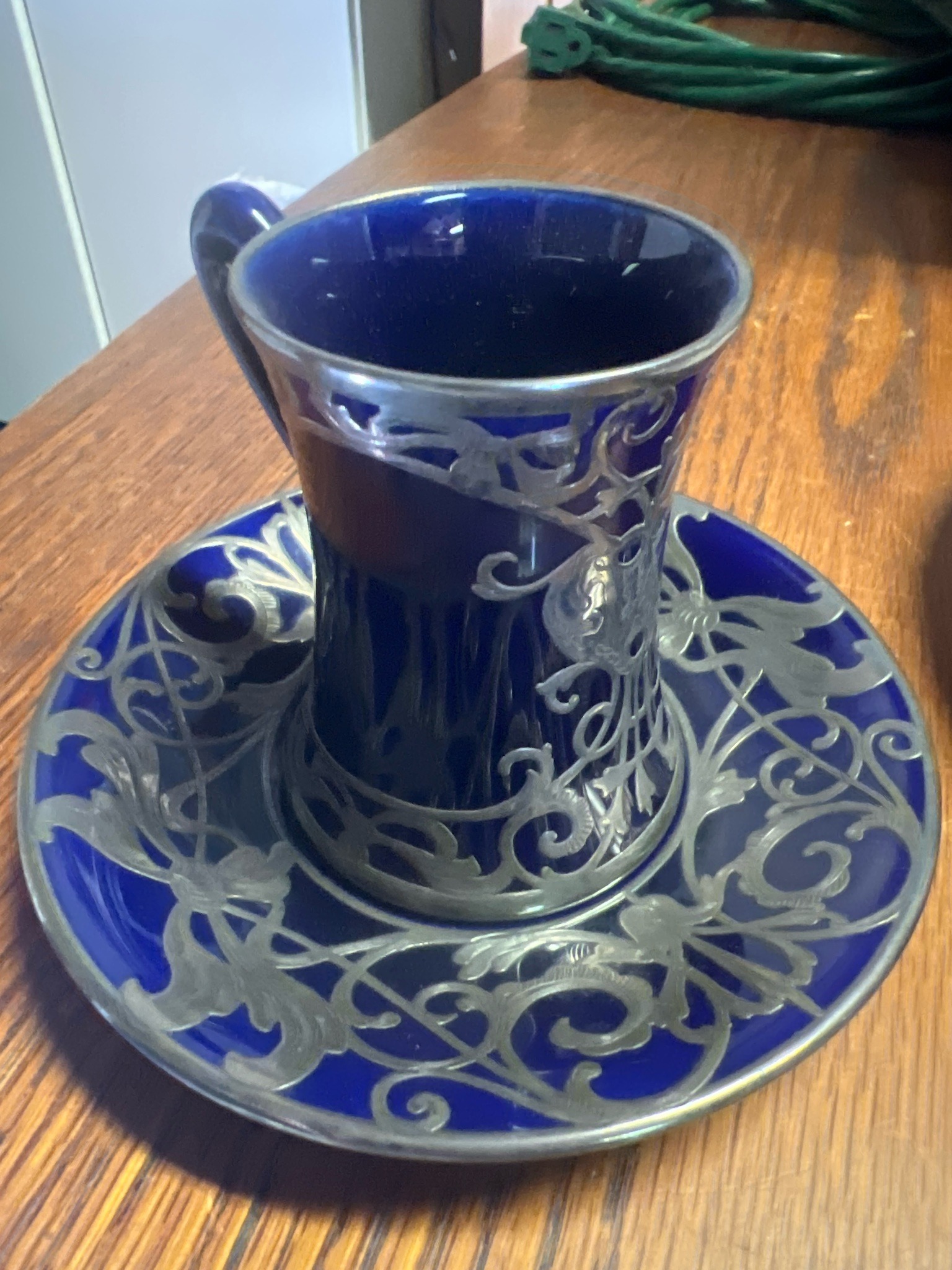 Submitted photo of Cobalt ceramic cup and saucer with silver overlay (not authenticated)