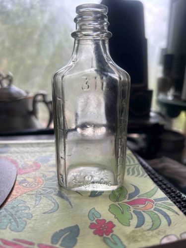 Vintage Clear Glass Bottle with Embossed Markings