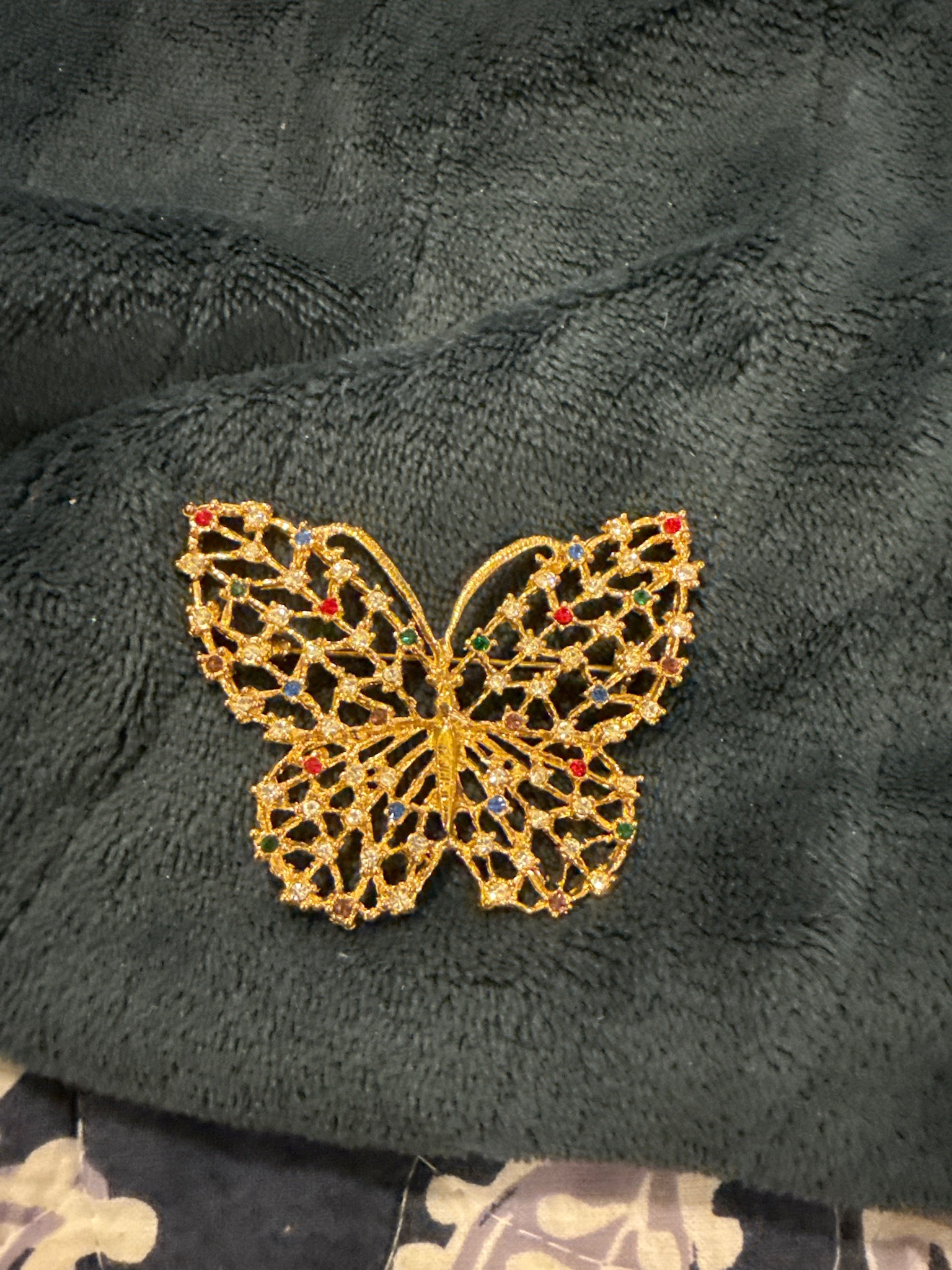 Submitted photo of Gold-tone butterfly figural brooch with multicolored rhinestones