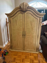 Ornate Wooden Armoire with Shell Motif