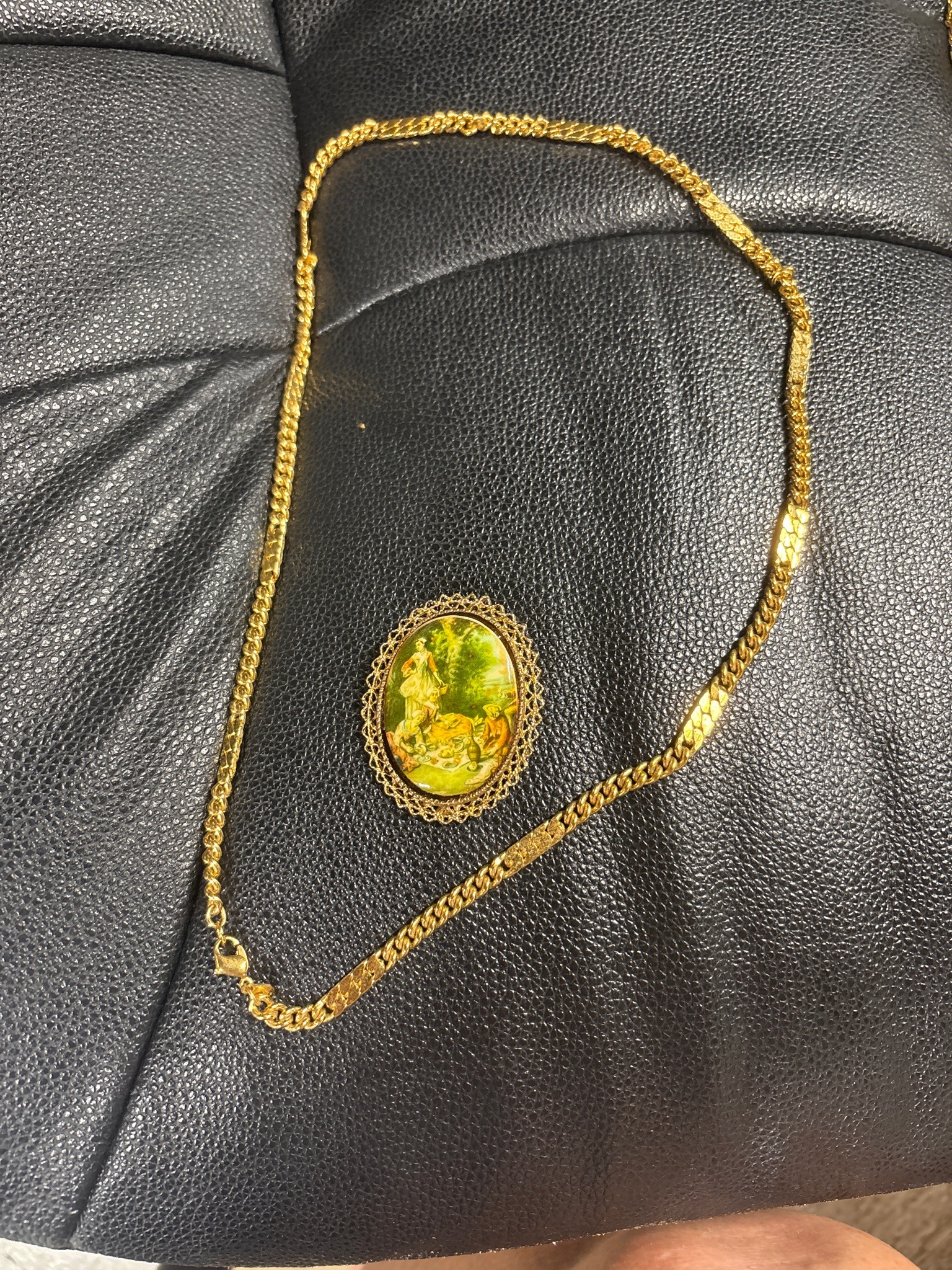 Submitted photo of Gold-tone pendant necklace with pictorial cameo