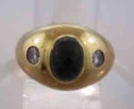Gold Ring with Central Oval Stone and Two Side Stones