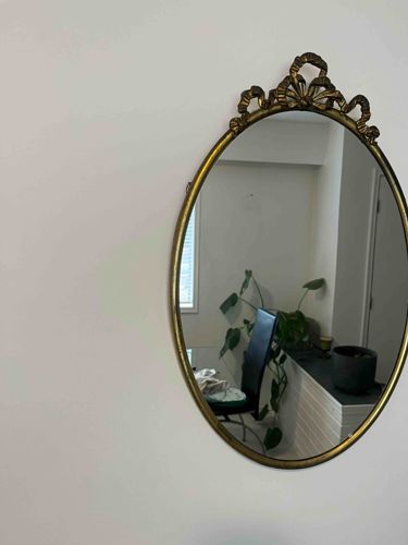 Vintage Oval Wall Mirror with Ornate Brass-Finished Crest