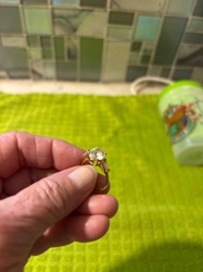 Yellow Metal Ring with Large Central Stone and Baguette Side Stones