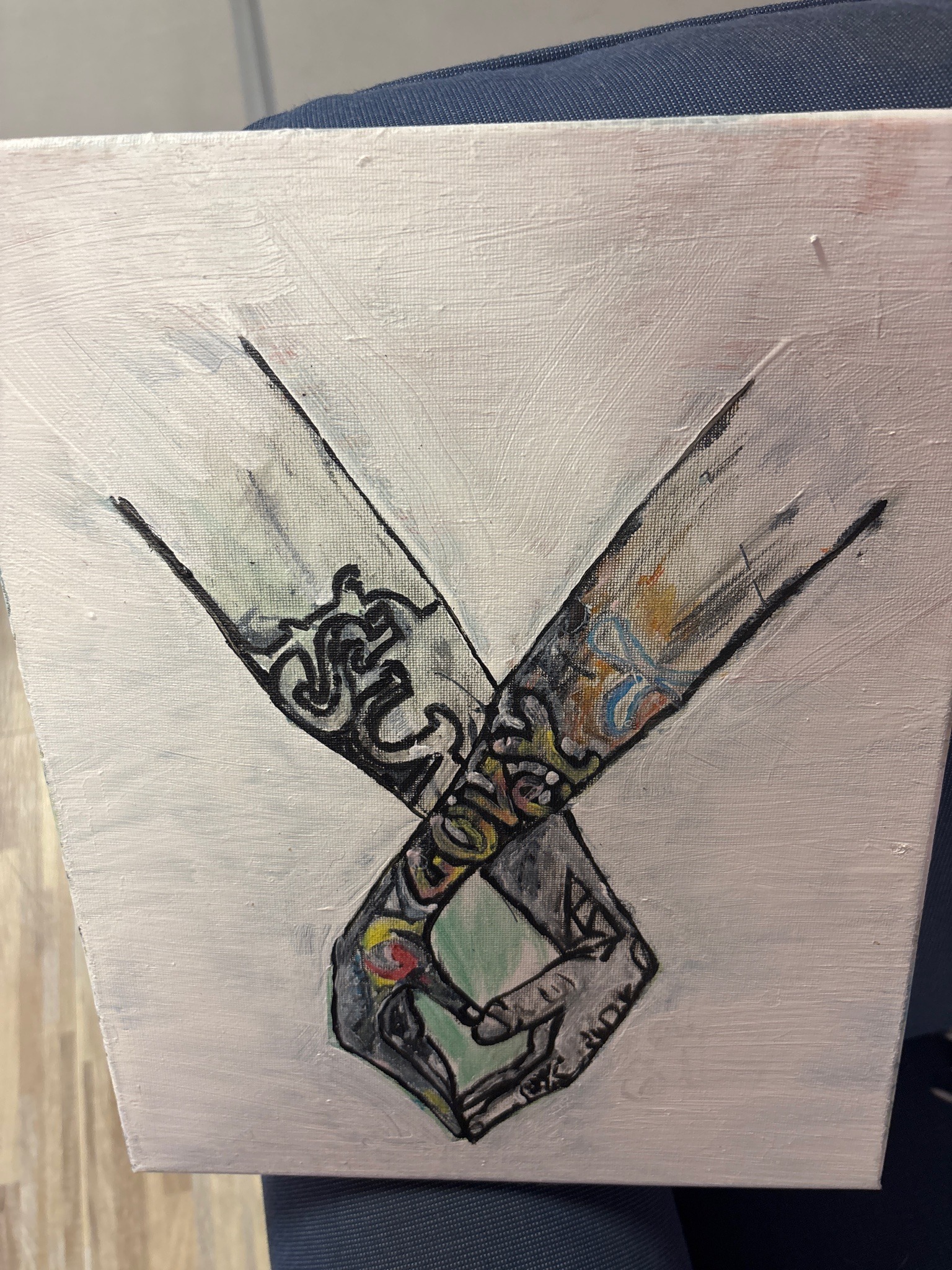 Submitted photo of Mixed media painting of intertwined tattooed arms