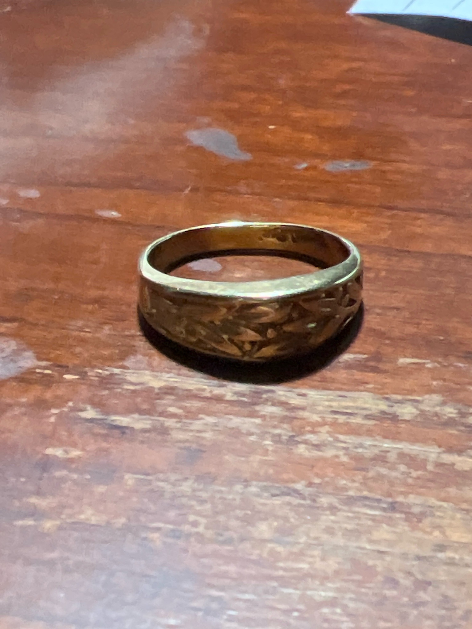 Submitted photo of Engraved gold band ring (unauthenticated)