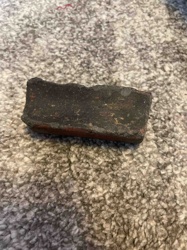 Fragment of a Darkened Brick or Ceramic Block