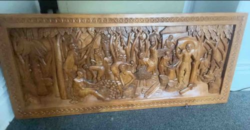 Hand-Carved Wooden Relief Panel Depicting a Village Scene