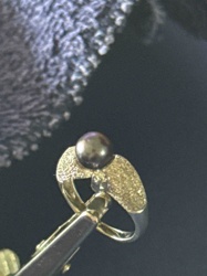 Gold Ring with Textured Shoulders and Dark Pearl