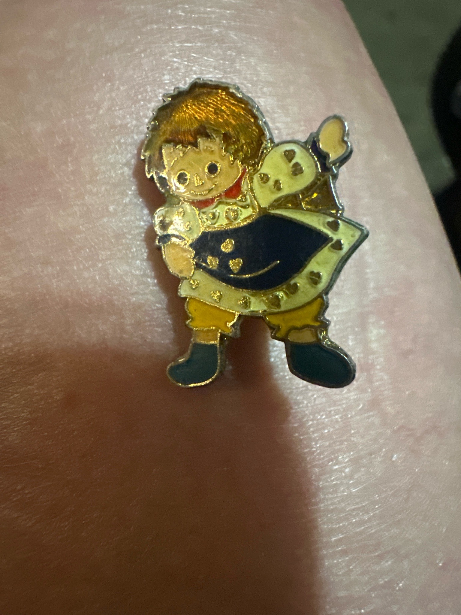 Submitted photo of Enamel lapel pin depicting a child character (unauthenticated)