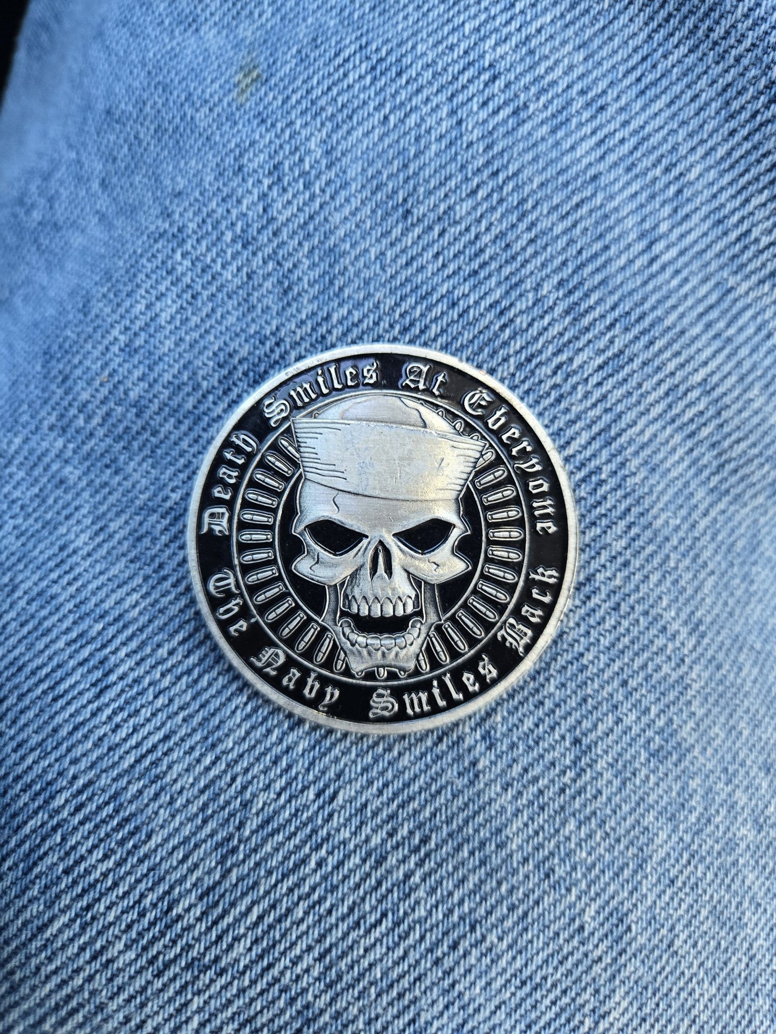 Submitted photo of Metal challenge coin bearing a skull wearing a sailor cap