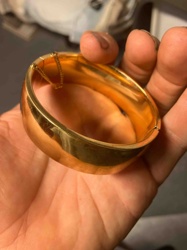 Wide Gold-Tone Hinged Bangle Bracelet with Safety Chain