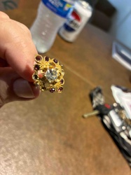Gold-Tone Flower Motif Ring with Central Clear Stone and Garnet Accents