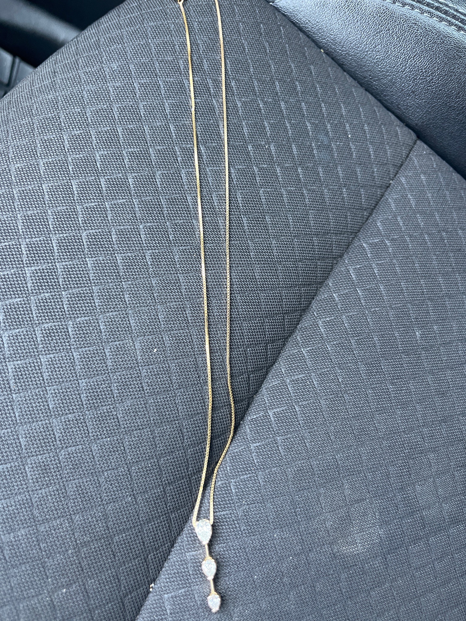 Submitted photo of Gold-tone chain necklace with stone pendant