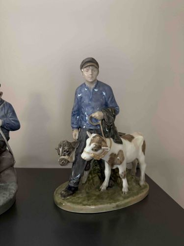 Porcelain Figurine of a Boy with Calves