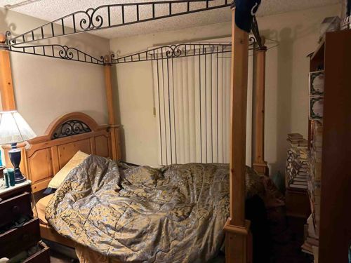 Four-Poster Canopy Bed with Wrought Iron Accents
