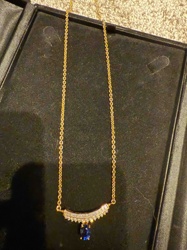 Gold-Toned Curved Bar Necklace with Pave Gemstones and Blue Oval Drop