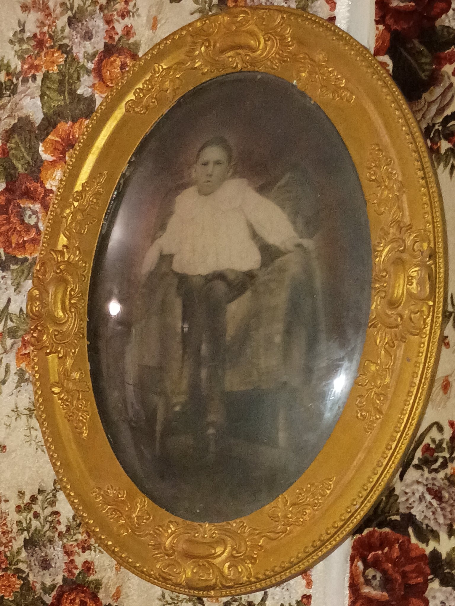 Submitted photo of Antique framed portrait photograph in ornate oval gilt frame