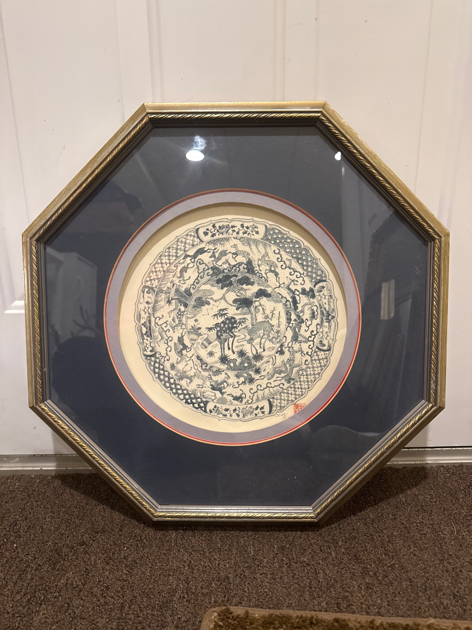 Submitted photo of Framed circular print featuring a detailed figural motif (not authenticated)