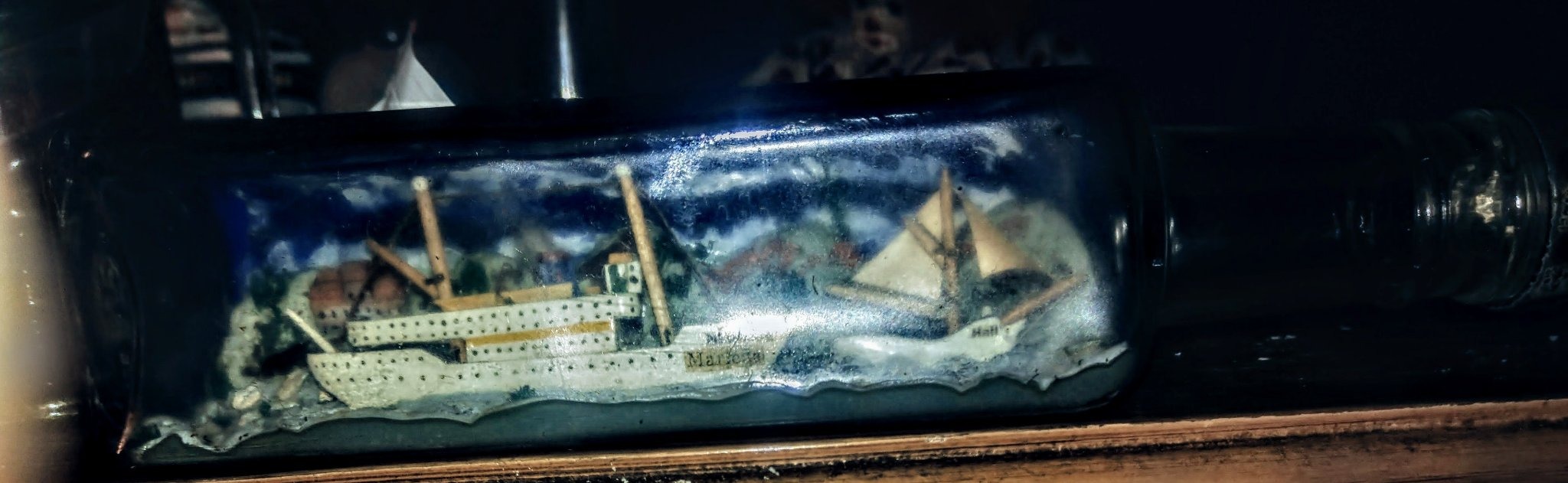 Submitted photo of Ship in a bottle featuring miniature nautical vessels