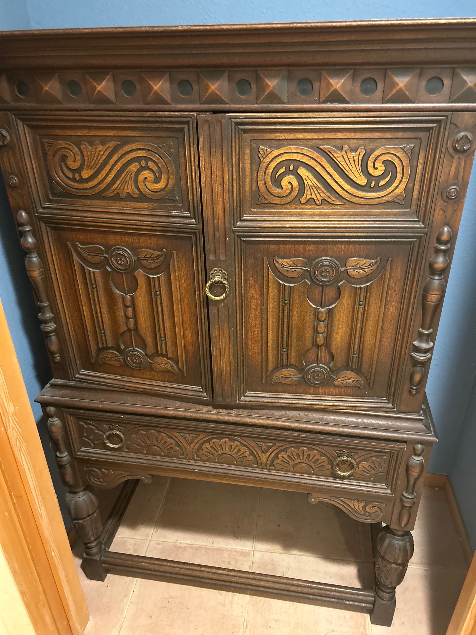 Submitted photo of Jacobean Revival style carved dark wood cabinet