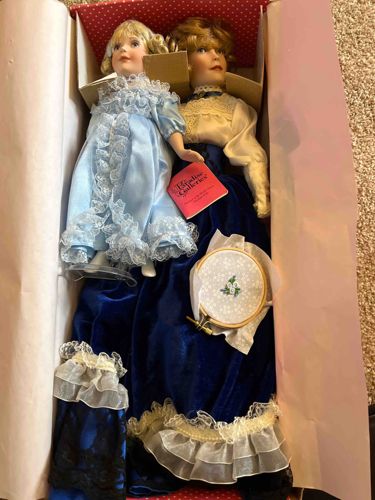 Two Porcelain Dolls with Accessories in Original Box