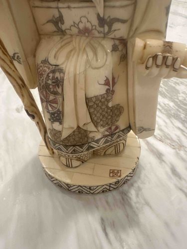 Carved and Painted Figurine with Staff and Scroll