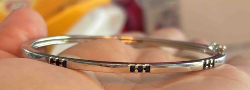 Silver-Toned Bangle Bracelet with Dark Stone Accents