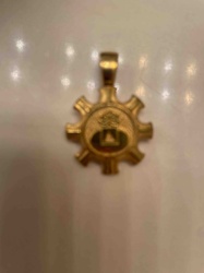 Gear-Shaped Emblematic Pendant with Tree and Pyramid Motif