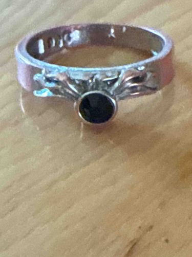 Silver-Toned Ring with Dark Gemstone and Filigree Accents