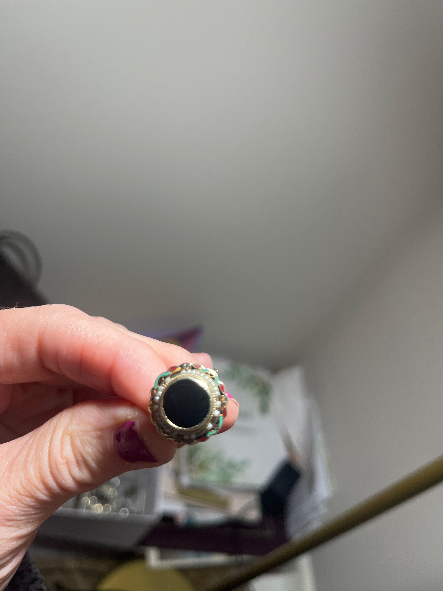 Submitted photo of Victorian-style ornamental ring featuring a central dark stone