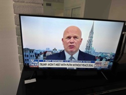 Flat-Screen Television Displaying News Broadcast