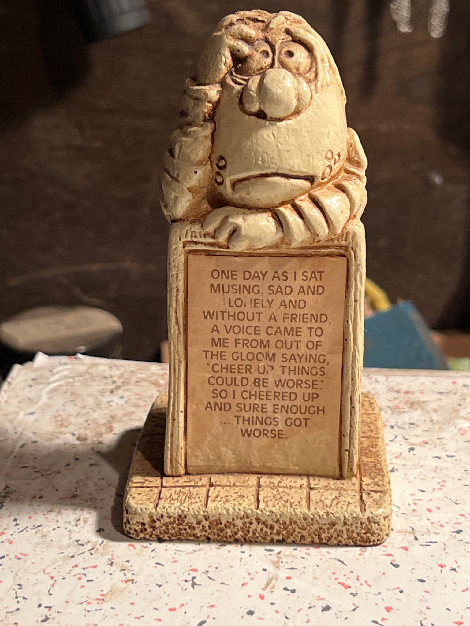 Submitted photo of Humorous figurine with inscribed pessimistic quote (unverified)