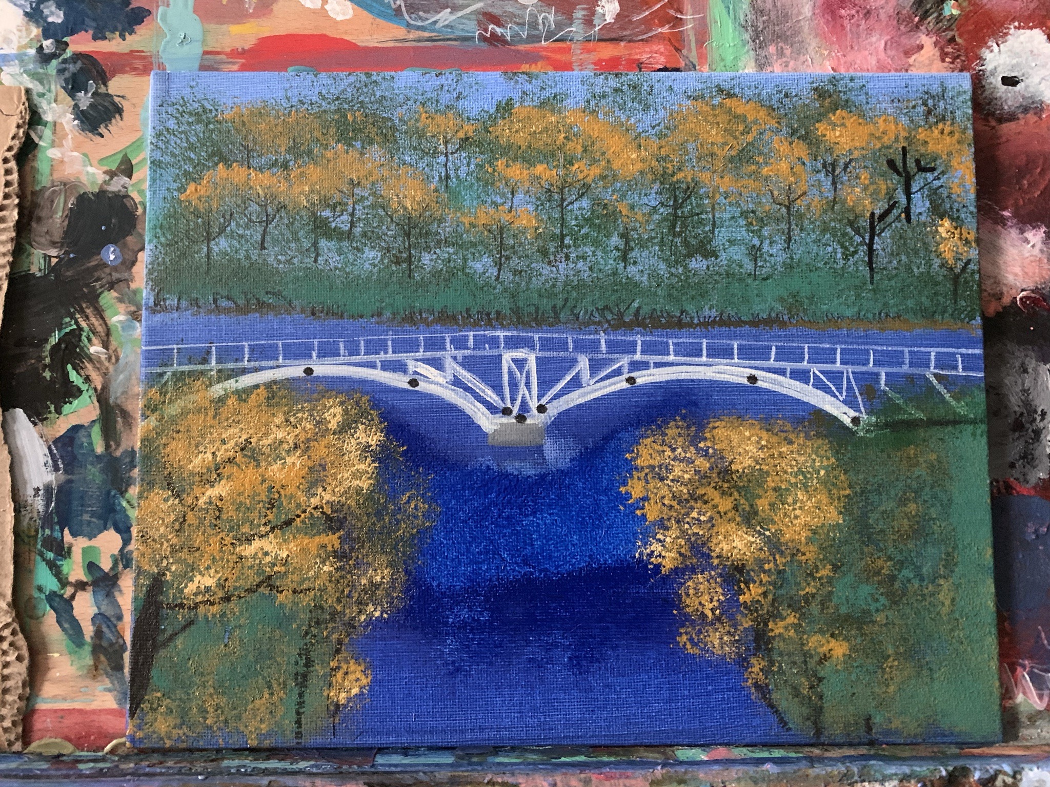 Submitted photo of Acrylic landscape painting of a bridge over a blue river