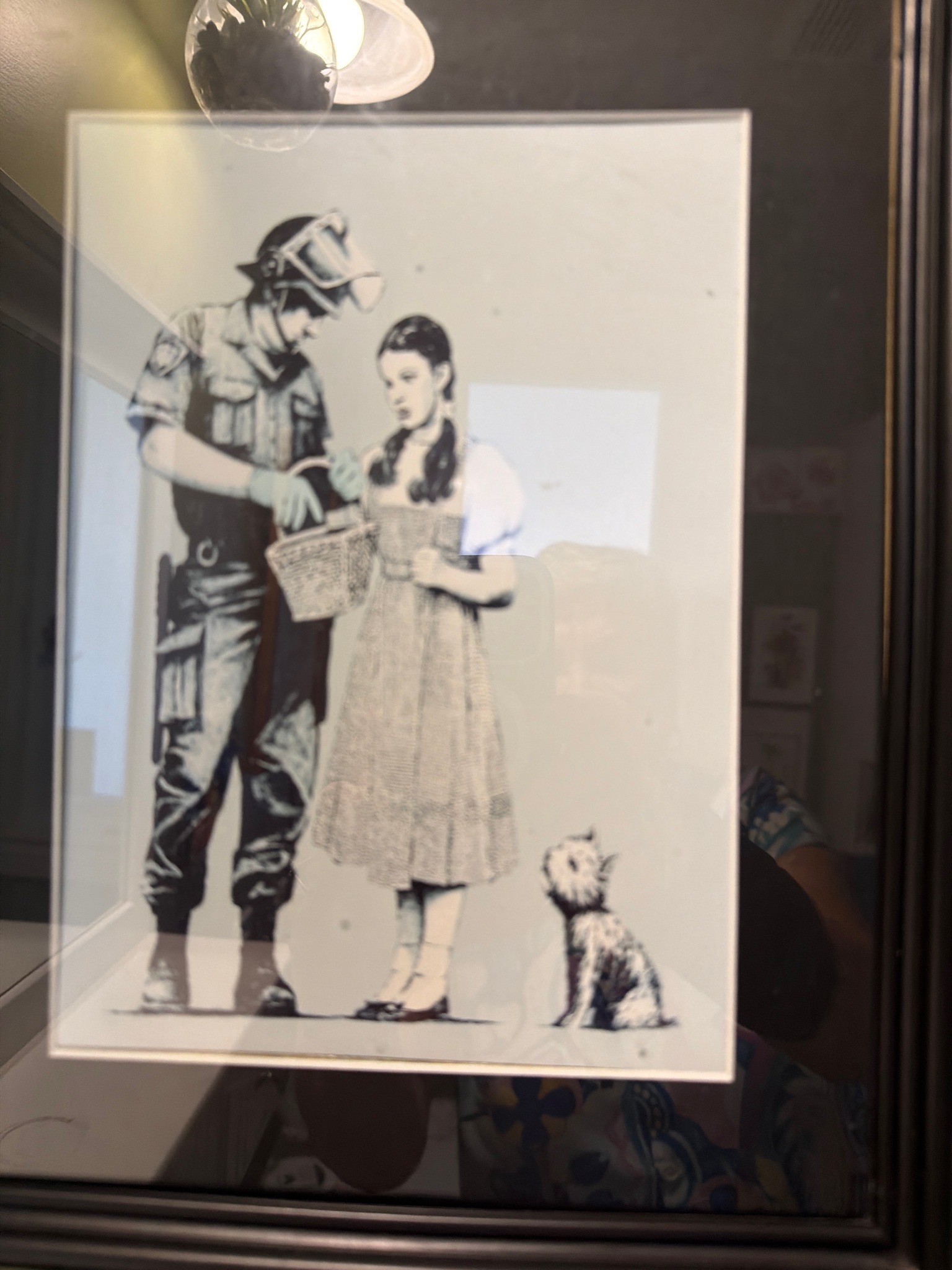 Submitted photo of Framed print featuring imagery associated with Banksy (not authenticated)