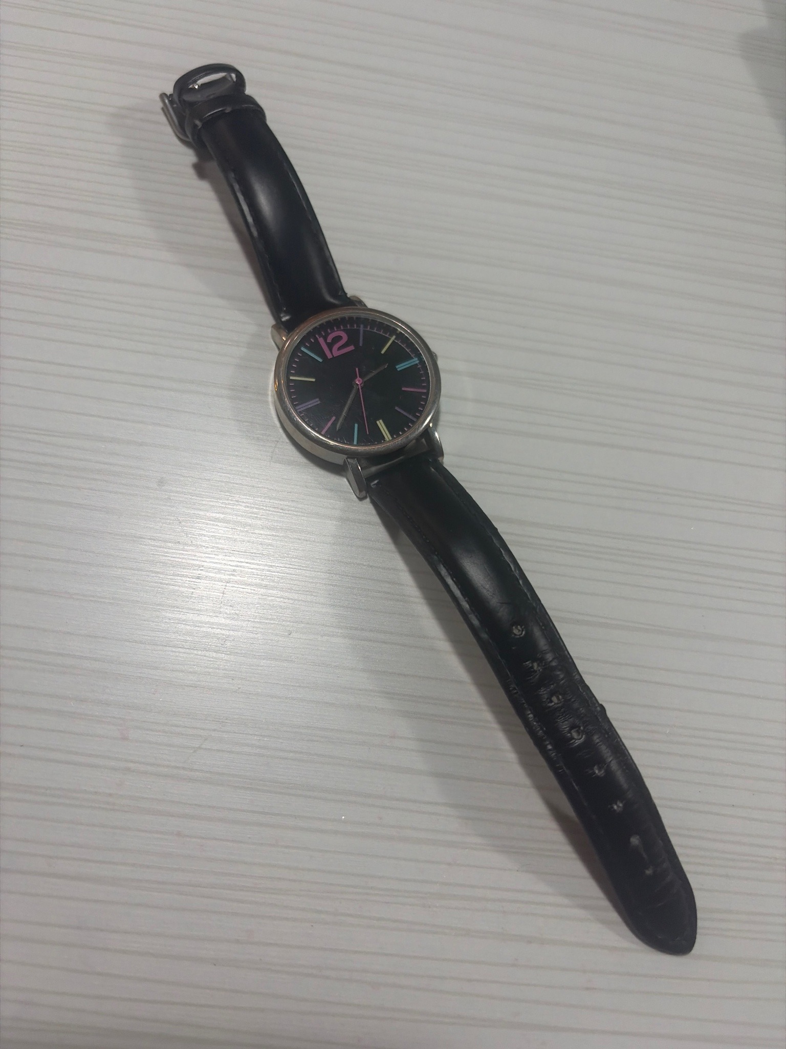 Submitted photo of Wristwatch with black dial and colorful hour markers