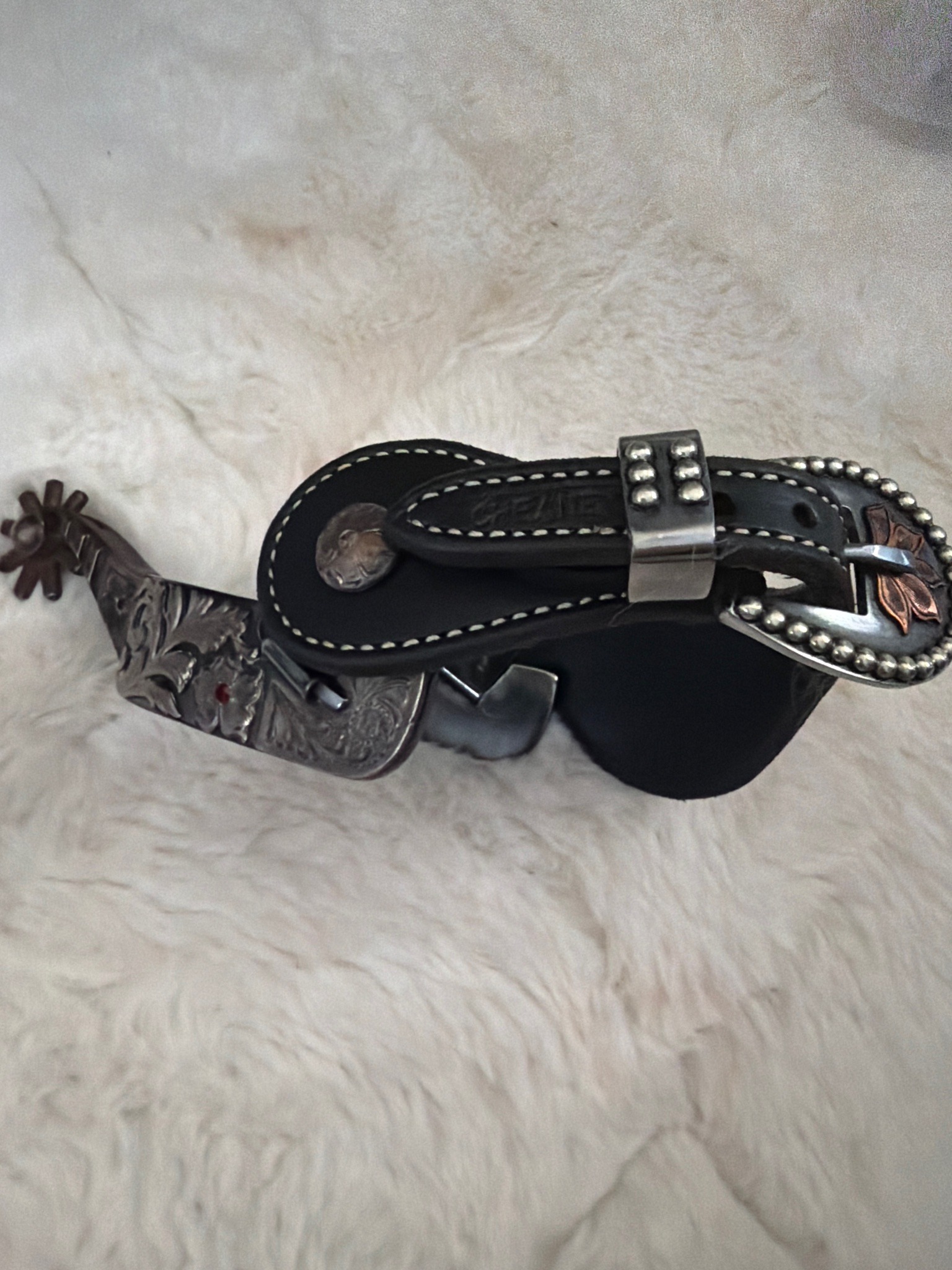 Submitted photo of Silver and leather spurs with engraved shank and straps (not authenticated)