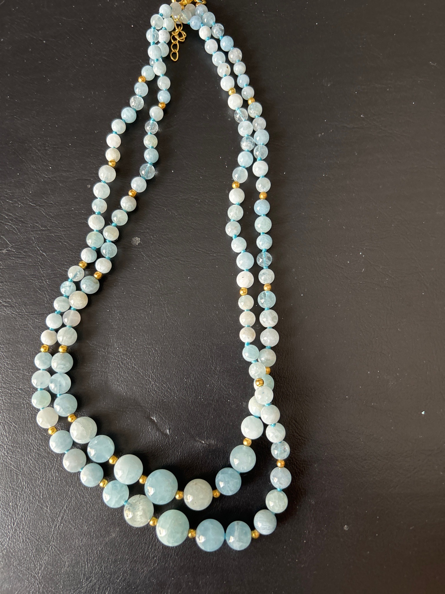 Submitted photo of Beaded gemstone necklace featuring pale blue aquamarine and gold-toned spacers