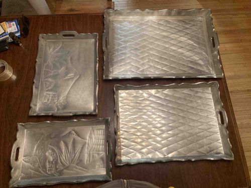 Collection of Four Mexican Punched Tin Over Wood Trays