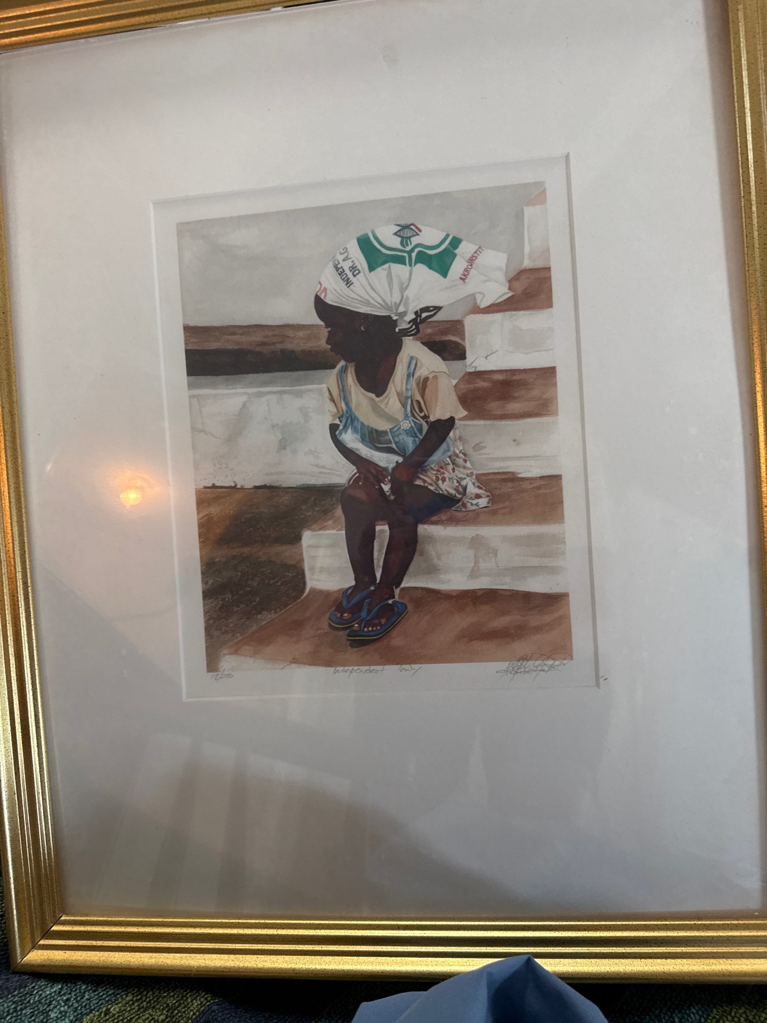 Submitted photo of Framed print depicting a child, signed 'John Biggers' (not authenticated)