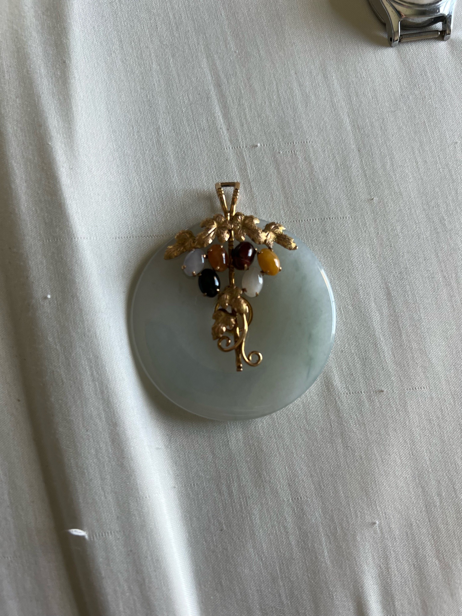 Submitted photo of Carved Jadeite Disc Pendant with Gold and Multi-Stone Cluster (not authenticated)