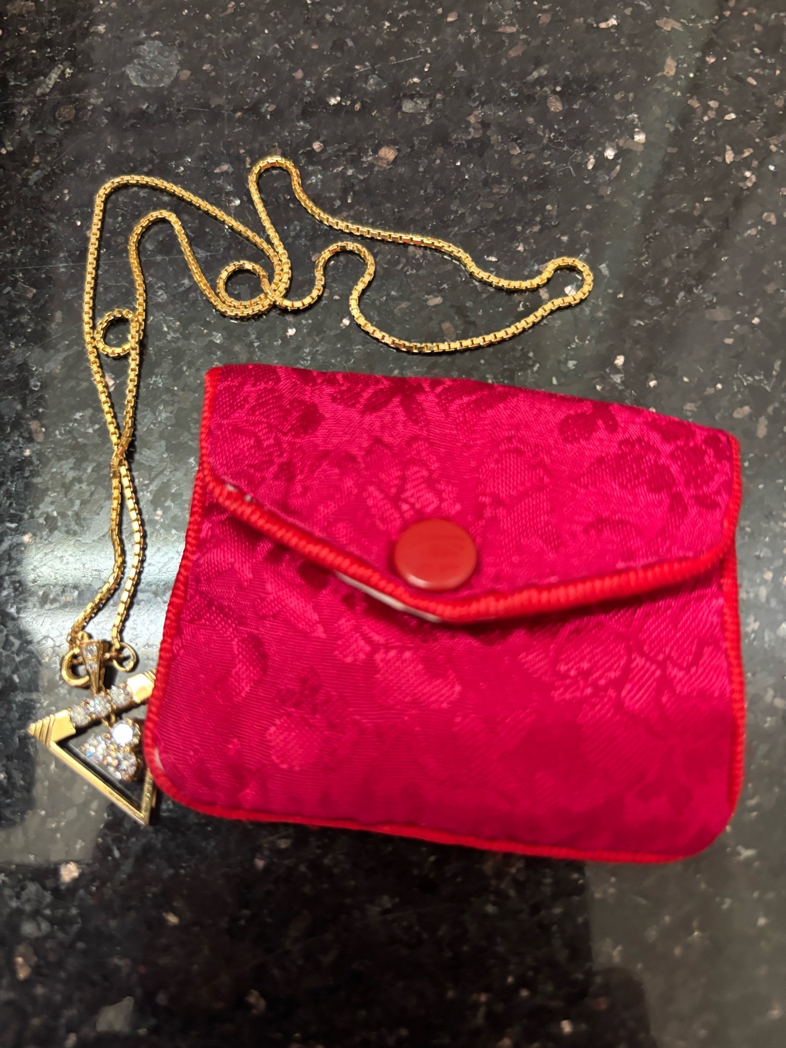 Submitted photo of Miniature red velvet pouch with gold-tone chain and pendant