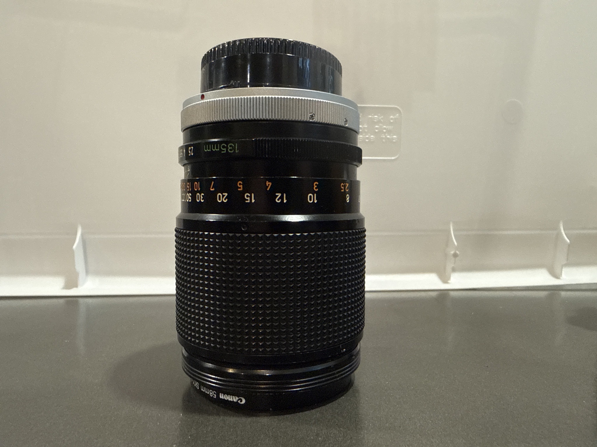 Submitted photo of Canon 135mm camera lens (not authenticated)