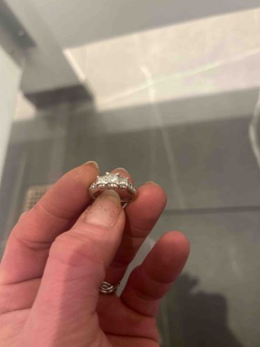 14 Karat White Gold Three-Stone Engagement Ring with Diamond Halo