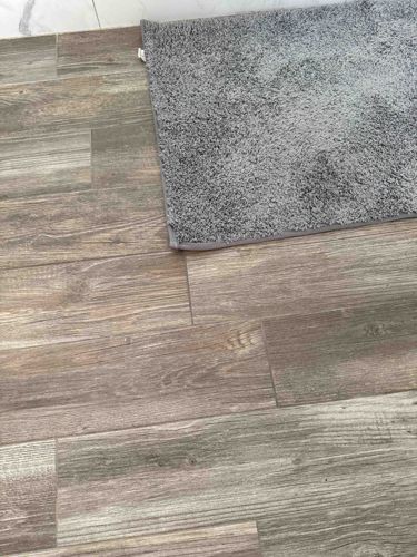 Gray Shag Bath Mat and Wood-Look Tile Flooring
