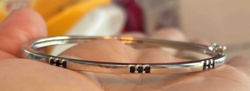 Silver-Toned Bangle Bracelet with Dark Stone Accents