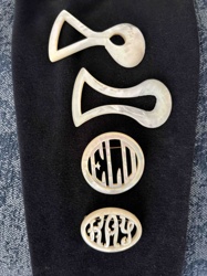 Collection of Mother-of-Pearl Items: Two Belt or Sash Buckles and Two Monogrammed Brooches