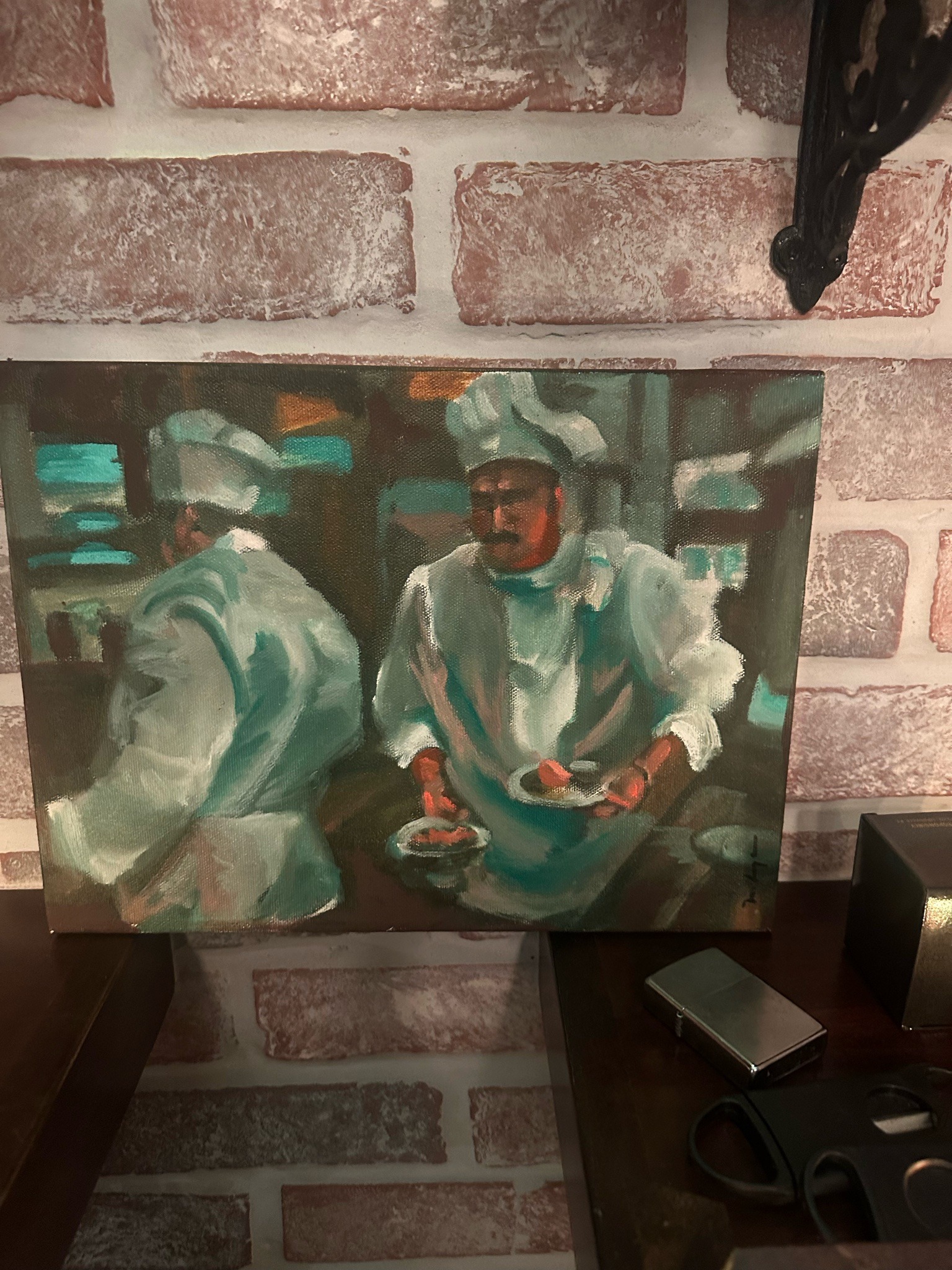 Submitted photo of Oil painting depicting kitchen chefs, bears a signature