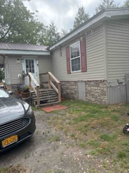 Manufactured Home with Wood Deck and Stone Skirting